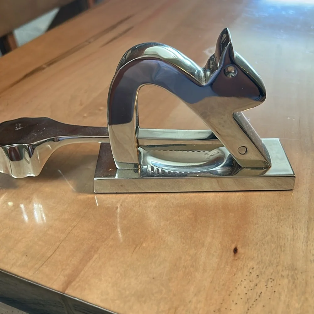 Crate and Barrel chromed squirrel nutcracker. Never used. Still has sticker.